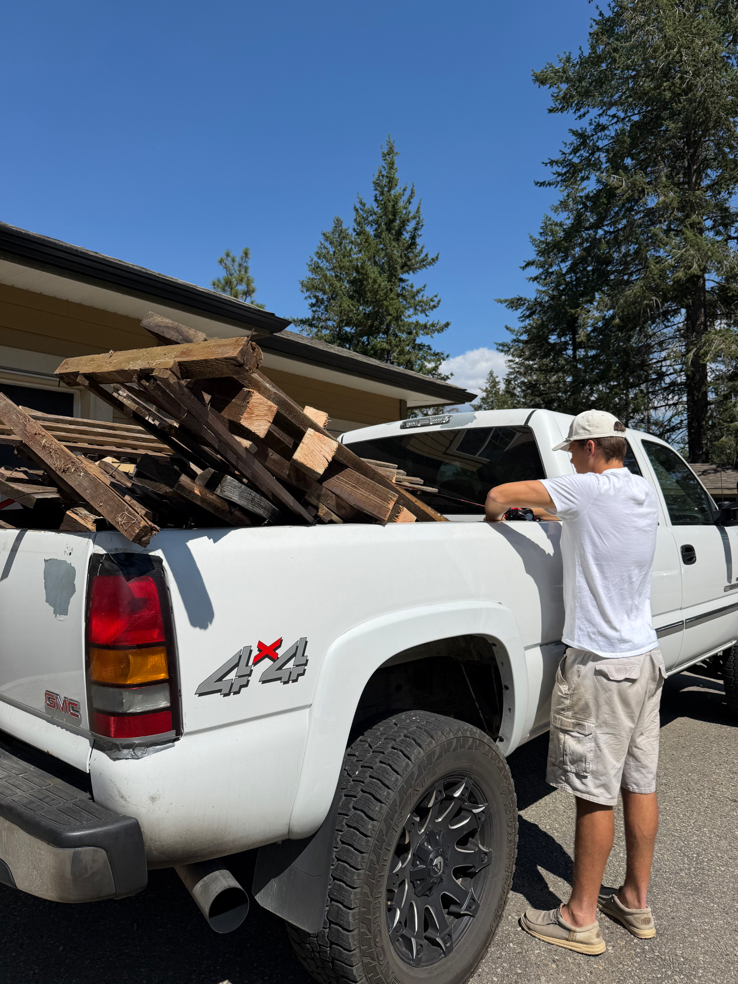 Jacob Glover loading the JK Junk Removal truck with lumber